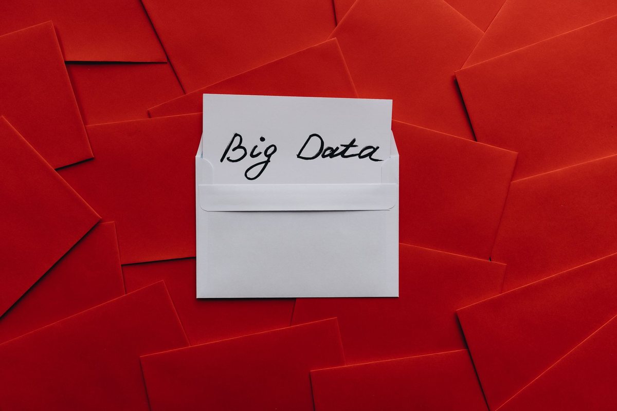 A close-up photo of a classic red paper Netflix DVD rental envelope on a wooden table.
