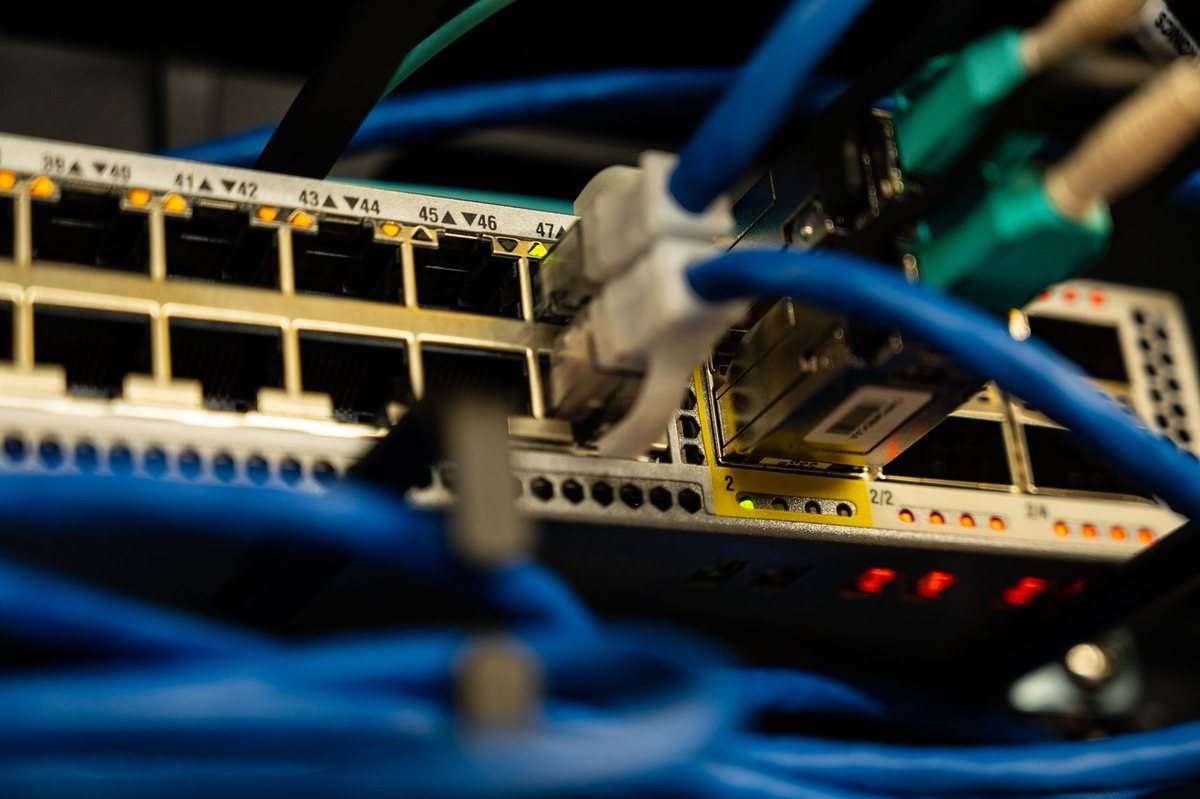 A photo of a bright red, rack-mounted Netflix Open Connect Appliance server inside a professional data center.